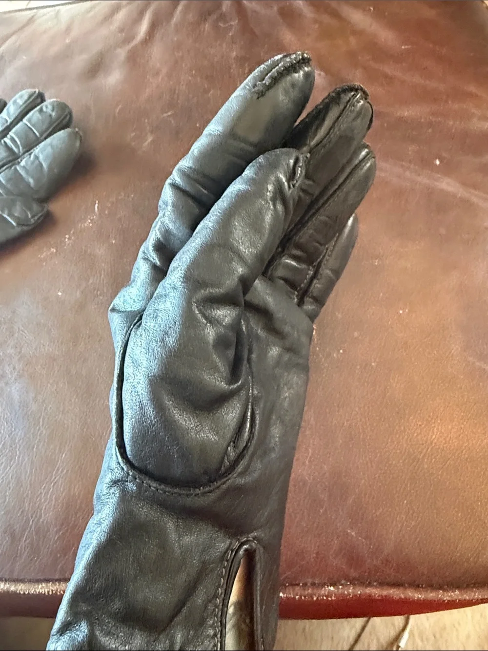 Genuine black leather gloves with genuine fur lining. Size medium
